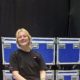 Lucy Primiano sitting on a Neg Earth Lights Flight Case.